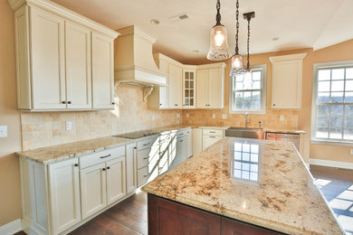 Large country l-shaped dark wood floor open concept kitchen photo in Philadelphia with a farmhouse sink, recessed-panel cabinets, white cabinets, beige backsplash, ceramic backsplash, stainless steel appliances and an island