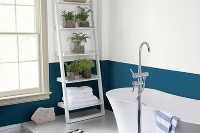Freestanding bathtub - large coastal master concrete floor and gray floor freestanding bathtub idea in New York with multicolored walls