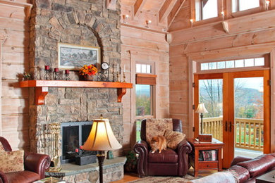 Inspiration for a large rustic formal and open concept dark wood floor and brown floor living room remodel in Philadelphia with beige walls, a standard fireplace, a stone fireplace and no tv