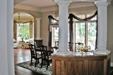 This is an example of a traditional dining room in Minneapolis with grey walls and dark hardwood floors.