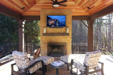 Example of a mid-sized trendy backyard tile patio design in Other with a fire pit and a gazebo
