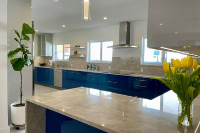 Large trendy galley porcelain tile and white floor eat-in kitchen photo in Miami with an undermount sink, flat-panel cabinets, blue cabinets, quartzite countertops, beige backsplash, stainless steel appliances, a peninsula and beige countertops