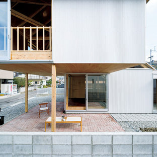 他の地域のコンテンポラリースタイルのおしゃれな横庭のテラス (レンガ敷き、張り出し屋根) の写真