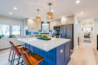 Small transitional l-shaped vinyl floor and beige floor open concept kitchen photo in Minneapolis with an undermount sink, shaker cabinets, blue cabinets, quartzite countertops, blue backsplash, ceramic backsplash, colored appliances, an island and white countertops