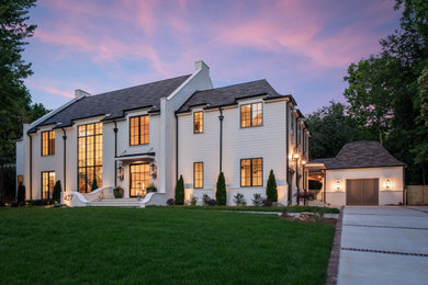 Huge white two-story brick house exterior photo in Charlotte with a shingle roof and a black roof