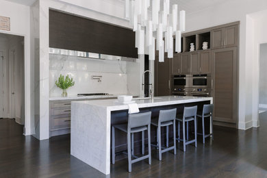 Mid-sized trendy dark wood floor and brown floor kitchen photo in Chicago with an undermount sink, white backsplash, stainless steel appliances, an island, white countertops, shaker cabinets, marble countertops, stone slab backsplash and dark wood cabinets
