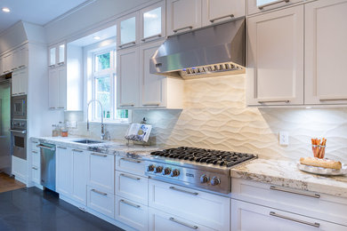 Large trendy light wood floor eat-in kitchen photo in Vancouver with an undermount sink, shaker cabinets, white cabinets, granite countertops, white backsplash, ceramic backsplash, stainless steel appliances and an island