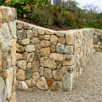 An attractive pea stone driveway offers a welcoming entry to the home