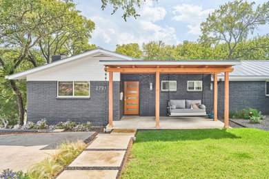Mid-sized trendy gray one-story brick house exterior photo in Austin with a metal roof