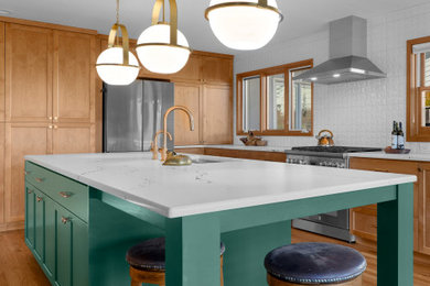 Kitchen - transitional l-shaped medium tone wood floor kitchen idea in Other with shaker cabinets, white backsplash, an island and white countertops