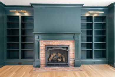 Elegant home office photo with a standard fireplace