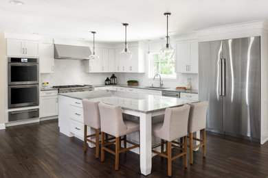Example of a large transitional dark wood floor eat-in kitchen design in New York with an undermount sink, shaker cabinets, granite countertops, white backsplash, marble backsplash, stainless steel appliances, an island and gray countertops