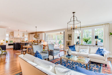 Living room - mid-sized traditional formal and open concept medium tone wood floor living room idea in Richmond with beige walls, a standard fireplace and no tv