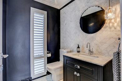 Small transitional powder room in Perth with recessed-panel cabinets, black cabinets, a two-piece toilet, gray tile, marble floors, a drop-in sink and marble benchtops.