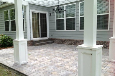 Patio - craftsman backyard brick patio idea in Atlanta with a roof extension
