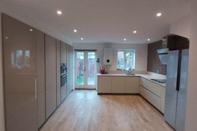 Contemporary kitchen in West Midlands with quartz worktops, beige splashback, engineered quartz splashback and beige worktops.