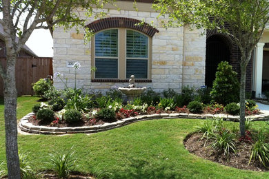 Photo of a large traditional full sun front yard concrete paver landscaping in Houston for summer.