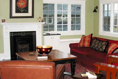 Large arts and crafts open concept medium tone wood floor living room library photo in Seattle with green walls, a standard fireplace, a metal fireplace and a wall-mounted tv