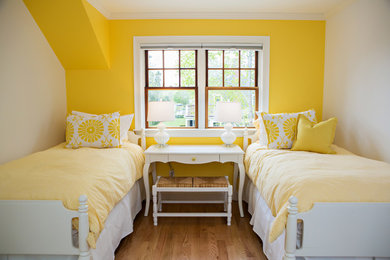 Inspiration for a mid-sized transitional guest medium tone wood floor and brown floor bedroom remodel in Boston with yellow walls and no fireplace