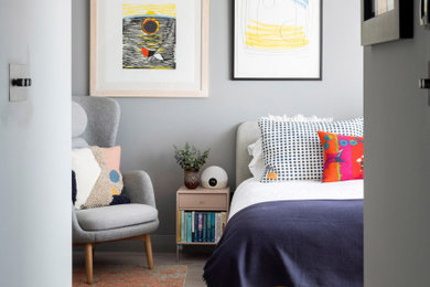 This is an example of a retro kids' bedroom in London with grey walls, light hardwood flooring and beige floors.