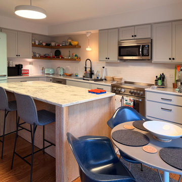 Curated Condo: Eclectic Kitchen, Light Wood Island, Veined Quartz