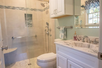 Inspiration for a small transitional master beige tile and porcelain tile porcelain tile, beige floor and single-sink bathroom remodel in Baltimore with white cabinets, a two-piece toilet, blue walls, an integrated sink, marble countertops, white countertops and a built-in vanity