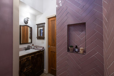 Inspiration for a small traditional 3/4 bathroom in Phoenix with shaker cabinets, dark wood cabinets, an alcove shower, terra-cotta tile, purple walls, concrete floors, a drop-in sink, tile benchtops, grey floor, a shower curtain, purple benchtops, a niche, a single vanity, a built-in vanity and vaulted.