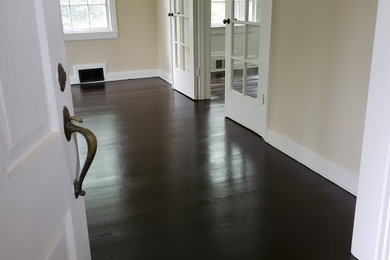 This is an example of a mid-sized traditional enclosed family room in Newark with dark hardwood floors.