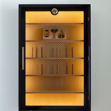 Wall hung high gloss black cigar humidor with polished brass hardware