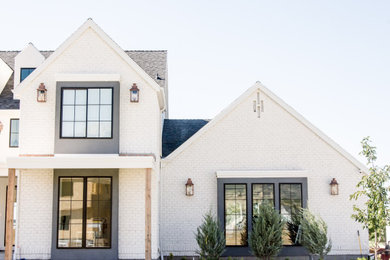 Example of a large transitional white two-story mixed siding house exterior design with a hip roof and a shingle roof