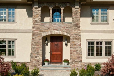 Large elegant beige two-story mixed siding exterior home photo in New York with a shingle roof