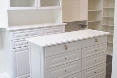 Example of a large classic gender-neutral carpeted and gray floor walk-in closet design in Los Angeles with raised-panel cabinets and white cabinets