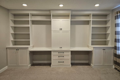 Design ideas for a mid-sized transitional home office in Cleveland with grey walls, carpet, a built-in desk and beige floor.