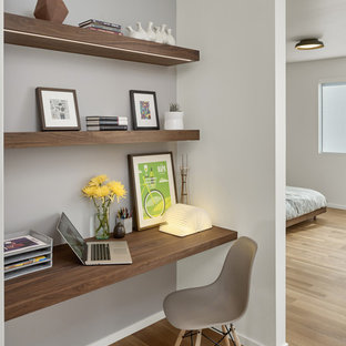 Design ideas for a small midcentury study in San Francisco with white walls, light hardwood flooring and a built-in desk.