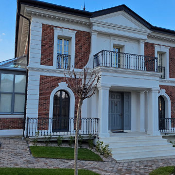 The finished facade in November 2025, with the portico stair