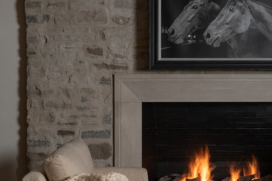 Family room - family room idea in Chicago with a two-sided fireplace and a stone fireplace