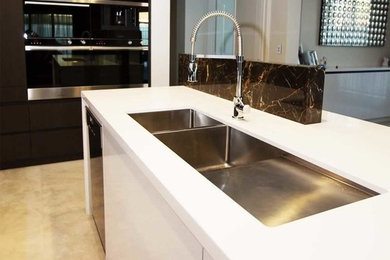 Kitchen in Perth with an undermount sink, quartz benchtops, marble splashback and with island.