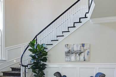 Inspiration for a large timeless carpeted curved wood railing staircase remodel in Los Angeles with carpeted risers
