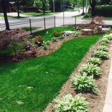Front and back sod installation with new garden beds.