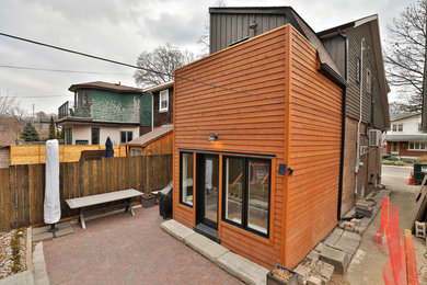 Inspiration for a mid-sized modern two-storey multi-coloured house exterior with mixed siding.