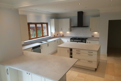 Contemporary kitchen in Sussex with shaker cabinets, quartzite benchtops, with island and beige benchtop.