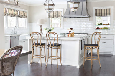 Eat-in kitchen - traditional l-shaped dark wood floor eat-in kitchen idea in Omaha with a farmhouse sink, shaker cabinets, white cabinets, white backsplash, subway tile backsplash, stainless steel appliances and an island