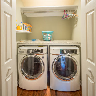 Small traditional single-wall laundry cupboard in Jacksonville with engineered stone countertops, beige walls, medium hardwood flooring, a side by side washer and dryer, brown floors and multicoloured worktops.