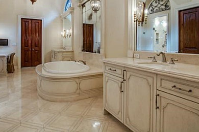 Bathroom - traditional stone tile marble floor bathroom idea in Dallas with marble countertops