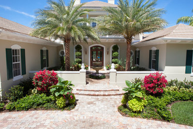 Photo of a full sun front yard brick garden path in Miami.