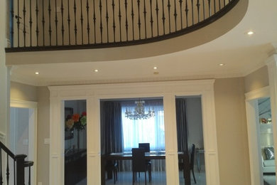 Inspiration for a mid-sized transitional beige floor foyer remodel in Toronto with beige walls