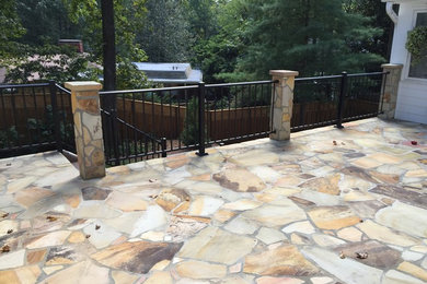 Mid-sized elegant backyard stone patio photo in Atlanta with no cover