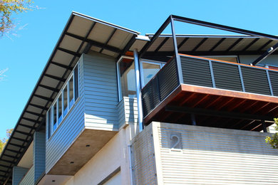 Inspiration for a modern two-storey concrete exterior in Central Coast with a flat roof.