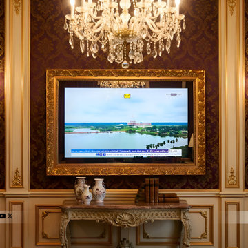 Statement Living Room Featuring an Ornate Gold Frame TV as Wall Art