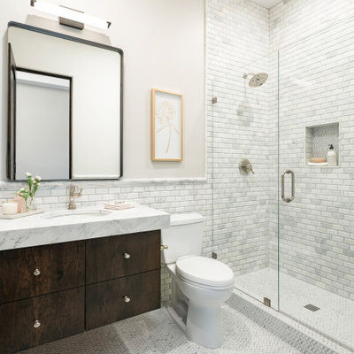 Alcove shower - mid-sized transitional white tile and marble tile porcelain tile, gray floor and single-sink alcove shower idea in Phoenix with flat-panel cabinets, dark wood cabinets, a one-piece toilet, gray walls, an undermount sink, marble countertops, a hinged shower door, white countertops and a floating vanity